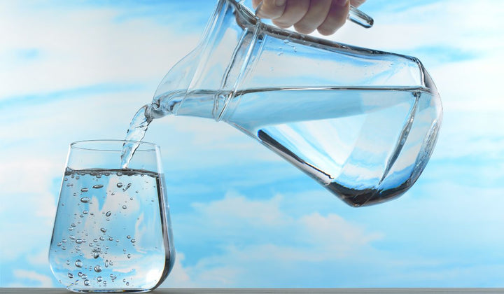 Purified water in a jug being poured into a glass