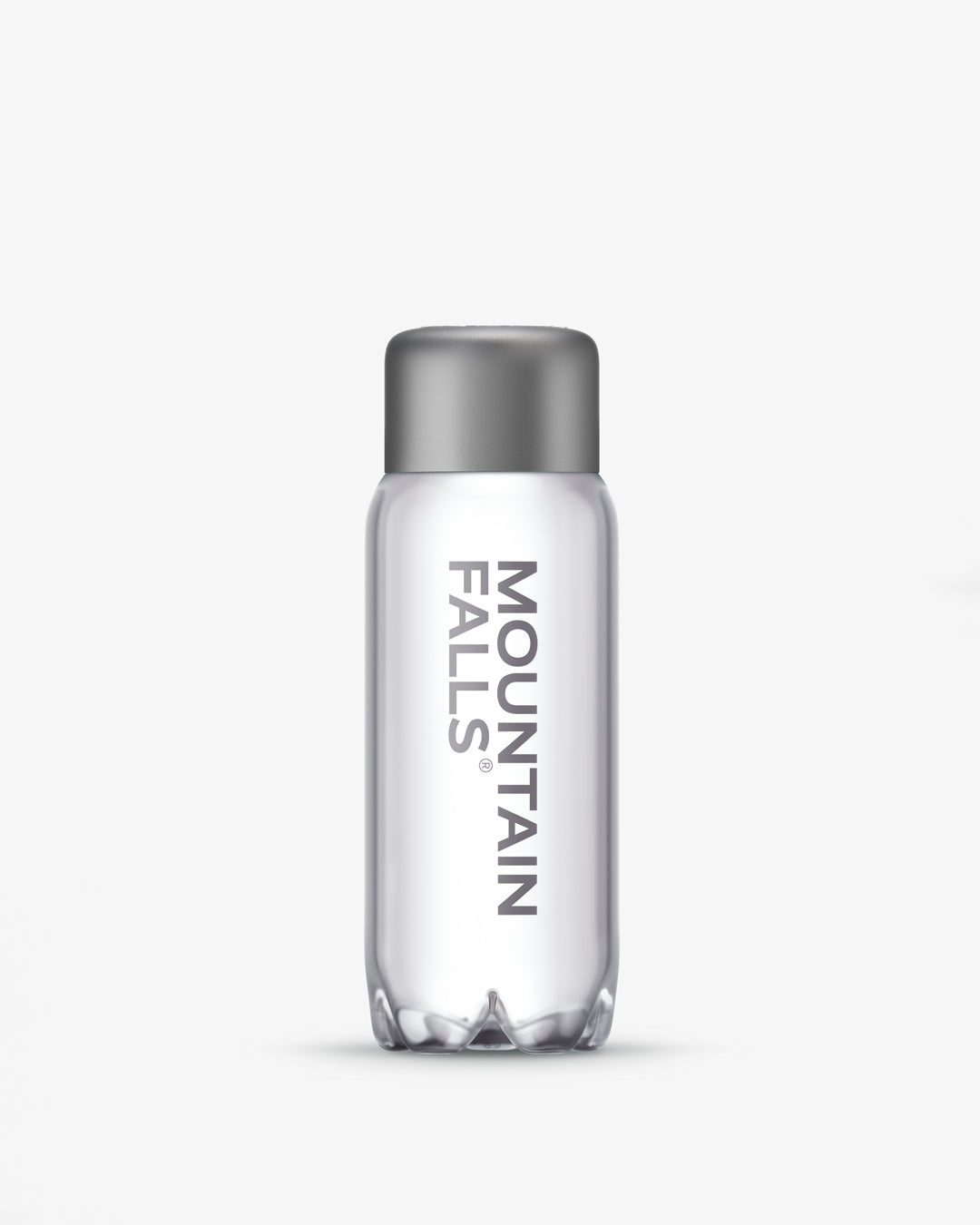 A 330ml sparkling mineral water bottle with the brand name Mountain Falls visible on the label.
